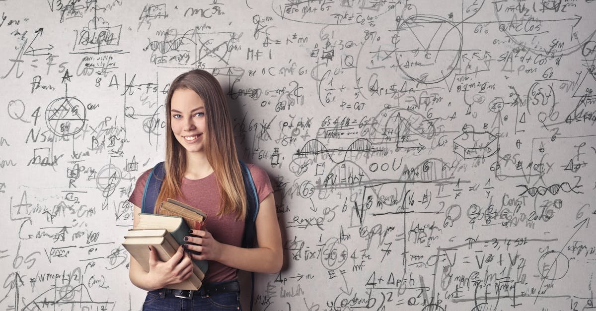 Young woman holding books standing in front of a chalkboard filled with mathematical formulas.
